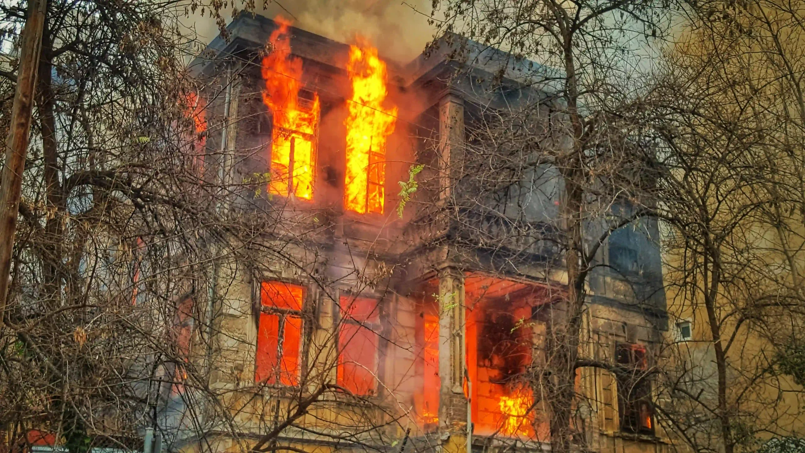 Casa incendiada, con árboles alrededor.